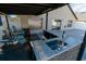 Granite outdoor kitchen and bar area featuring sink, built-in lighting, and bar seating at 2822 Moultrie Creek Dr, Kissimmee, FL 34743