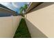 Narrow side yard featuring a well-maintained fence and a strip of green grass at 2822 Moultrie Creek Dr, Kissimmee, FL 34743
