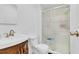 Bathroom featuring a glass-door shower, white toilet, and a sink at 3139 Morning Light Way, Kissimmee, FL 34744