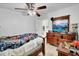 Comfortable bedroom featuring a ceiling fan, dresser with a television, and a wooden bed frame at 3139 Morning Light Way, Kissimmee, FL 34744