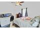 Bedroom with bed, ceiling fan, and dresser with drawers and a door to the outside at 3139 Morning Light Way, Kissimmee, FL 34744