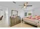 Well-lit bedroom featuring a ceiling fan, a window, and a bed at 3139 Morning Light Way, Kissimmee, FL 34744