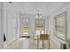 Bright dining area with a glass table and white seating, open to kitchen and outdoor access at 3139 Morning Light Way, Kissimmee, FL 34744