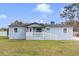 Charming single story home with a white porch railing, blue siding and green front lawn at 3139 Morning Light Way, Kissimmee, FL 34744