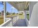 Covered front porch with white wooden pillars and railings, offering a peaceful outdoor space at 3139 Morning Light Way, Kissimmee, FL 34744