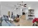 Open living area with tile floors, ceiling fans, and access to the outdoor patio at 3139 Morning Light Way, Kissimmee, FL 34744