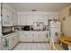 Functional kitchen with ample cabinet space, white appliances, and a clean, tiled floor at 319 Michigan Ave, St Cloud, FL 34769