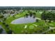 Aerial view showcases a lush golf course with lakes and trees at 3214 Candle Ridge Dr # 201, Orlando, FL 32822