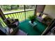 Cozy screened balcony with seating and a view of the green lawn and surrounding trees at 3214 Candle Ridge Dr # 201, Orlando, FL 32822