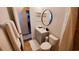 Bathroom with gray vanity, round mirror, and gray accent rug at 3214 Candle Ridge Dr # 201, Orlando, FL 32822