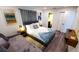 Bedroom boasts an art piece, a large bed, and hardwood floors at 3214 Candle Ridge Dr # 201, Orlando, FL 32822