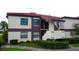 Two story condominium building showing a terracotta roof and lush landscaping at 3214 Candle Ridge Dr # 201, Orlando, FL 32822