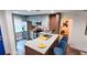 Updated kitchen features stainless appliances and a granite island with seating and bedroom view at 3214 Candle Ridge Dr # 201, Orlando, FL 32822