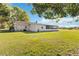 Beautiful backyard featuring a spacious screened-in lanai and a lush green lawn, ideal for relaxing at 3260 Osceola Rd, St Cloud, FL 34772
