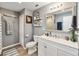 Bathroom with gray walls, updated vanity, and wood-look tile flooring at 3260 Osceola Rd, St Cloud, FL 34772