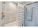 Bathroom stall with gray tile, towel bar, and blue-striped shower curtain at 3260 Osceola Rd, St Cloud, FL 34772