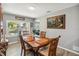 Classic dining room with wood table and chairs, large window, and view to living room at 3260 Osceola Rd, St Cloud, FL 34772