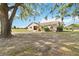 Well-maintained single-story home with a large front yard and mature landscaping under a blue sky at 3260 Osceola Rd, St Cloud, FL 34772