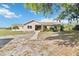 Charming single-story home featuring a landscaped yard and a welcoming walkway under a clear blue sky at 3260 Osceola Rd, St Cloud, FL 34772
