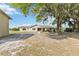 Single-story home with a spacious front yard and mature tree, offering a serene setting at 3260 Osceola Rd, St Cloud, FL 34772