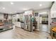 Bright kitchen featuring stainless steel refrigerator, updated cabinets, and view to living room at 3260 Osceola Rd, St Cloud, FL 34772