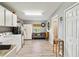 Laundry room with a sofa, washer, dryer, extra storage, and a door to the backyard at 3260 Osceola Rd, St Cloud, FL 34772