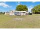 Large outbuilding with multiple bays and a trailer, offering ample storage on a spacious lawn at 3260 Osceola Rd, St Cloud, FL 34772