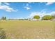 Vast property with a single-Gathering home and a large outbuilding set amidst an expansive green lawn at 3260 Osceola Rd, St Cloud, FL 34772