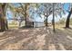 Outdoor shed surrounded by mature trees, providing a rustic storage solution at 3260 Osceola Rd, St Cloud, FL 34772