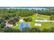 Aerial view of a neighborhood park featuring a basketball court and playground at 3317 Schoolhouse Rd, Harmony, FL 34773