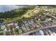 Aerial view showcasing a lakeside community with beautiful homes and mature trees at 3317 Schoolhouse Rd, Harmony, FL 34773