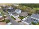 Aerial view of a residential neighborhood with a pond and golf course in the background at 3317 Schoolhouse Rd, Harmony, FL 34773