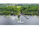A beautiful lake with a dock and surrounding lush trees at 3317 Schoolhouse Rd, Harmony, FL 34773