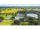 Aerial view showcasing the community pool, tennis courts, and scenic green spaces for recreation at 3317 Schoolhouse Rd, Harmony, FL 34773