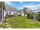 Lush green backyard with stepping stones, privacy hedges, and an AC unit at 3317 Schoolhouse Rd, Harmony, FL 34773