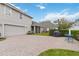 Paver driveway and patio with a grill and outdoor seating, surrounded by green grass at 3317 Schoolhouse Rd, Harmony, FL 34773