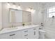 Bright bathroom with double vanity, gold fixtures, marble countertops, framed mirror, and shower-tub combo at 3317 Schoolhouse Rd, Harmony, FL 34773