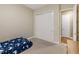 Neutral bedroom features a twin bed, and a double closet with door to another room and beige carpet at 3317 Schoolhouse Rd, Harmony, FL 34773