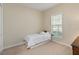 Cozy bedroom with a single bed, a neutral color scheme, and natural light from a window at 3317 Schoolhouse Rd, Harmony, FL 34773