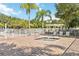 Relaxing community spa with a tiled patio, surrounded by palm trees and lounge chairs at 3317 Schoolhouse Rd, Harmony, FL 34773
