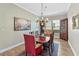 Elegant dining room with a chandelier, artwork, and traditional furnishings at 3317 Schoolhouse Rd, Harmony, FL 34773