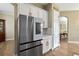 Open concept kitchen with stainless steel refrigerator and white cabinets at 3317 Schoolhouse Rd, Harmony, FL 34773