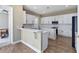 Modern kitchen with white cabinetry, quartz countertops, and stainless steel appliances at 3317 Schoolhouse Rd, Harmony, FL 34773