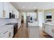 Well-designed kitchen with an island, white cabinets, and stainless appliances at 3317 Schoolhouse Rd, Harmony, FL 34773