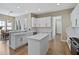 Bright kitchen featuring an island, white cabinets, and wood floors at 3317 Schoolhouse Rd, Harmony, FL 34773