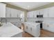 Beautiful kitchen with white cabinets, an island, and stainless steel appliances at 3317 Schoolhouse Rd, Harmony, FL 34773