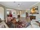 Spacious living room featuring hardwood floors, a ceiling fan, and an entertainment center at 3317 Schoolhouse Rd, Harmony, FL 34773