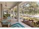 Relaxing front porch featuring cozy seating and views of the lush neighborhood at 3317 Schoolhouse Rd, Harmony, FL 34773