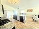 Modern kitchen with granite countertops, stainless appliances, island with bar seating and hardwood floors at 334 Sonja Cir, Davenport, FL 33897