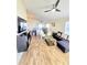 Open-concept living room and dining area with vaulted ceilings, hardwood floors, and sliding door at 334 Sonja Cir, Davenport, FL 33897